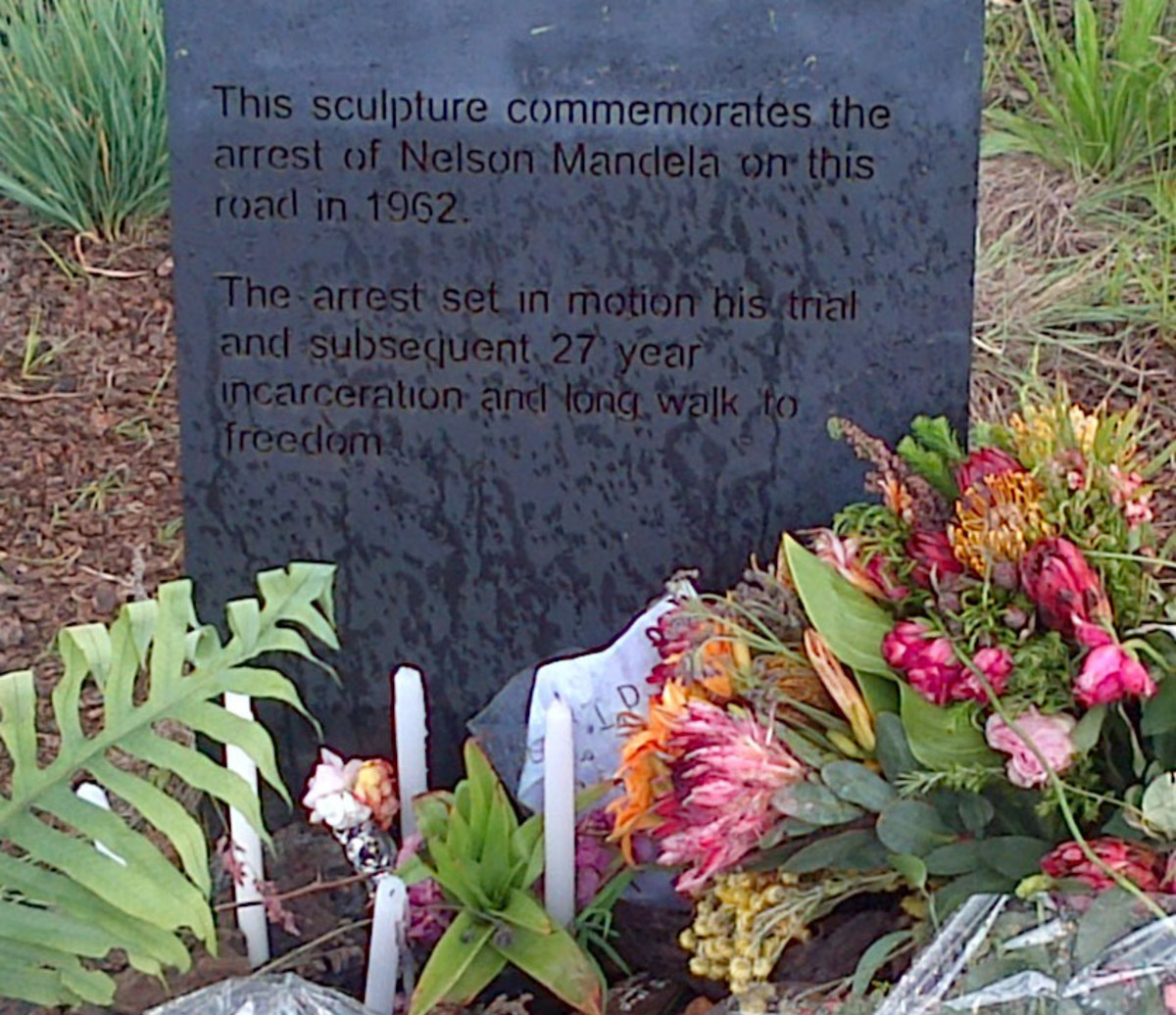 The official plaque at the foot of the sculpture