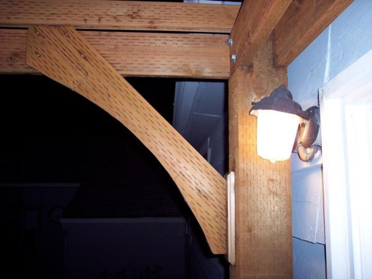 Here's another problem you may run into. Just behind the light and directly behind the 6x6, you can just see the original light fixture box. We mounted a new box and ran a short conduit piece over to remount the porch light.