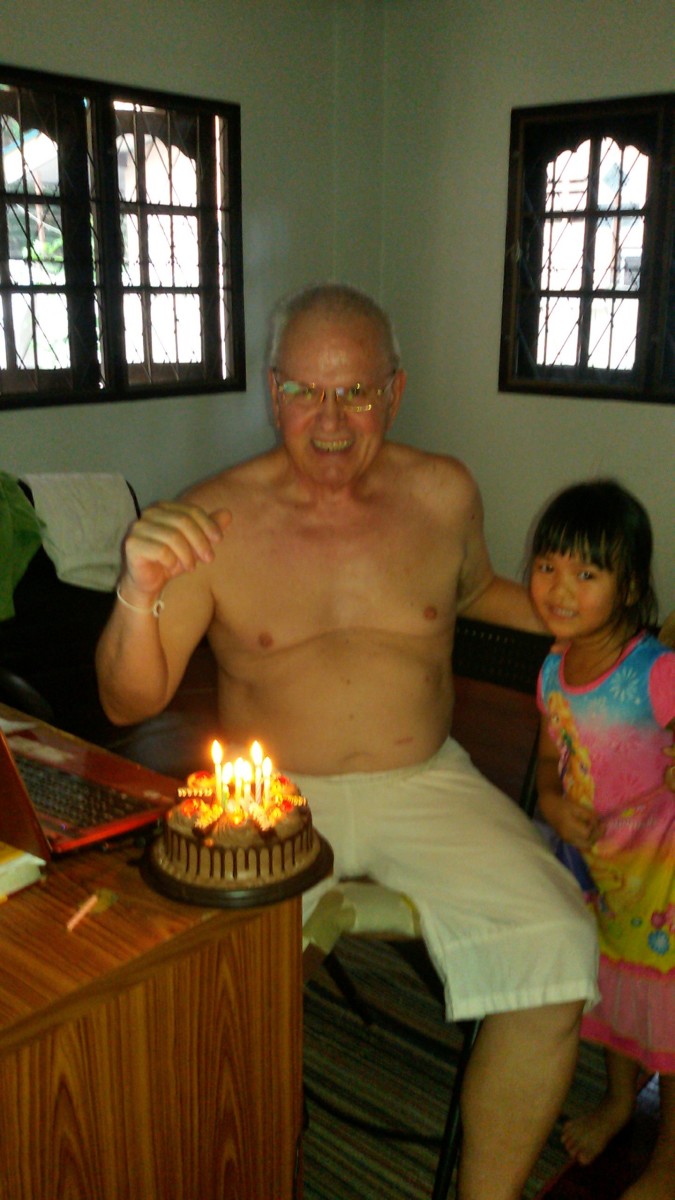 Getting ready to blow out birthday cake candles with granddaughter Yuri.