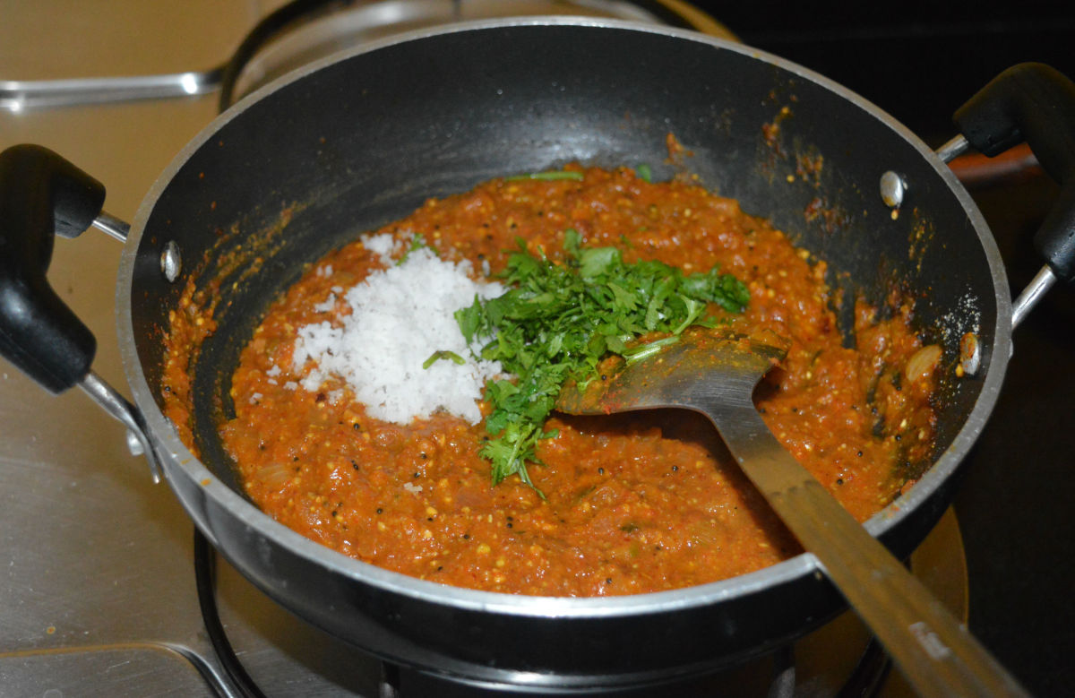 Step four: Throw in grated coconut and chopped coriander leaves. Mix well and continue to saute for 1-2 minutes.