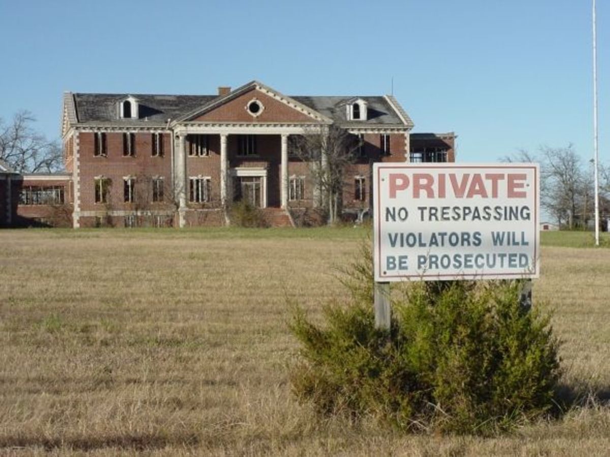 A "No Trespassing" sign in front of the property