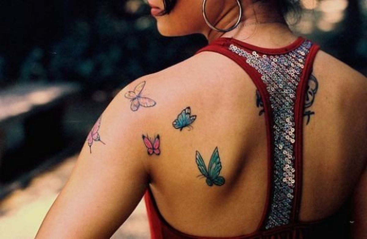 This person has several butterfly tattoos on her back and shoulder.