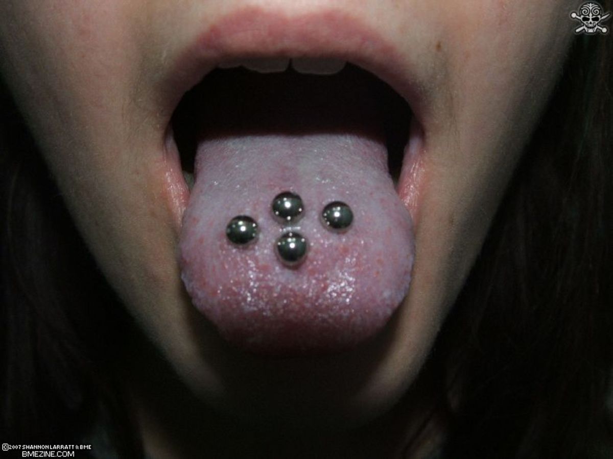 close-up of someone with multiple tongue piercings