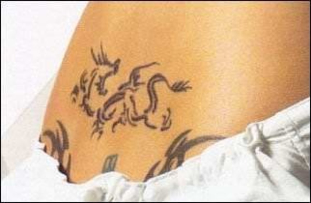 Blue dragon tattoo with tribal design elements.