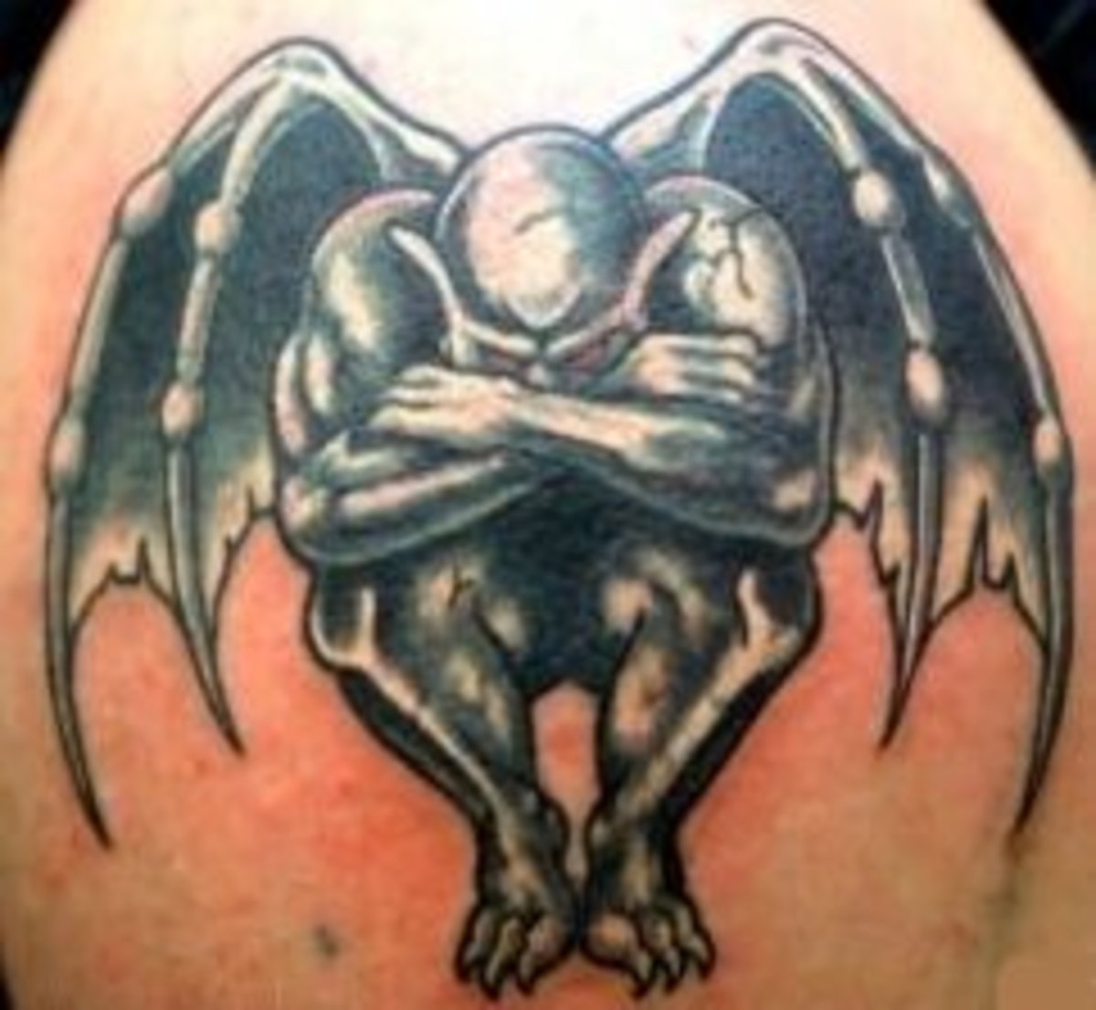 A winged gargoyle tattoo.