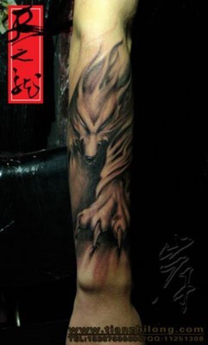 Tattoo of running wolf on arm