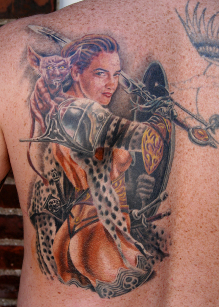 Detailed female warrior tattoo with fantastical design elements.