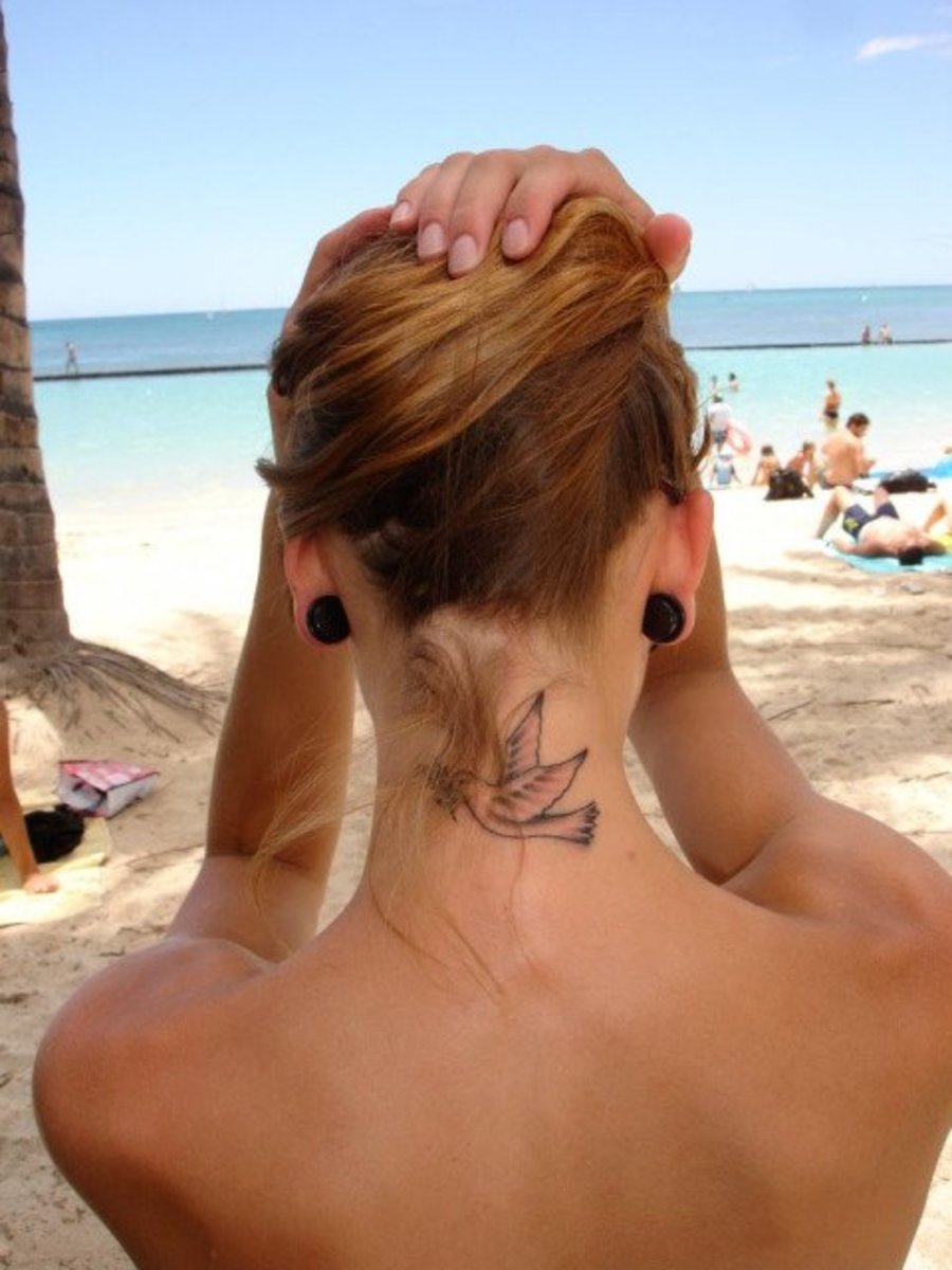 Woman With a Dove Tattoo on Her Neck