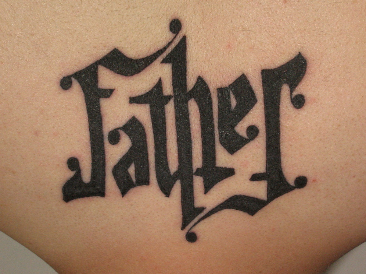 Mirror-image ambigram tattoo reading "Father"