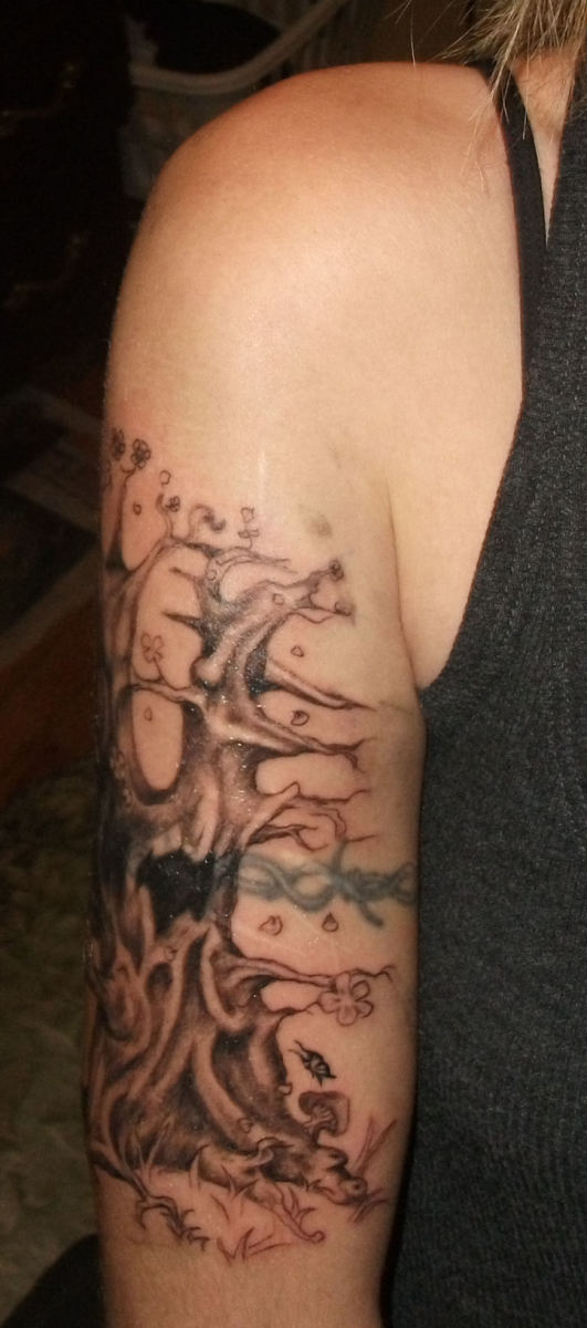 You can see how he had to go darker in the middle where the barbed wire was. I wanted the whole tree to be light and airy. You can also see the barbed wire ruining the look of the new tree tat. There are still some scars showing as well.
