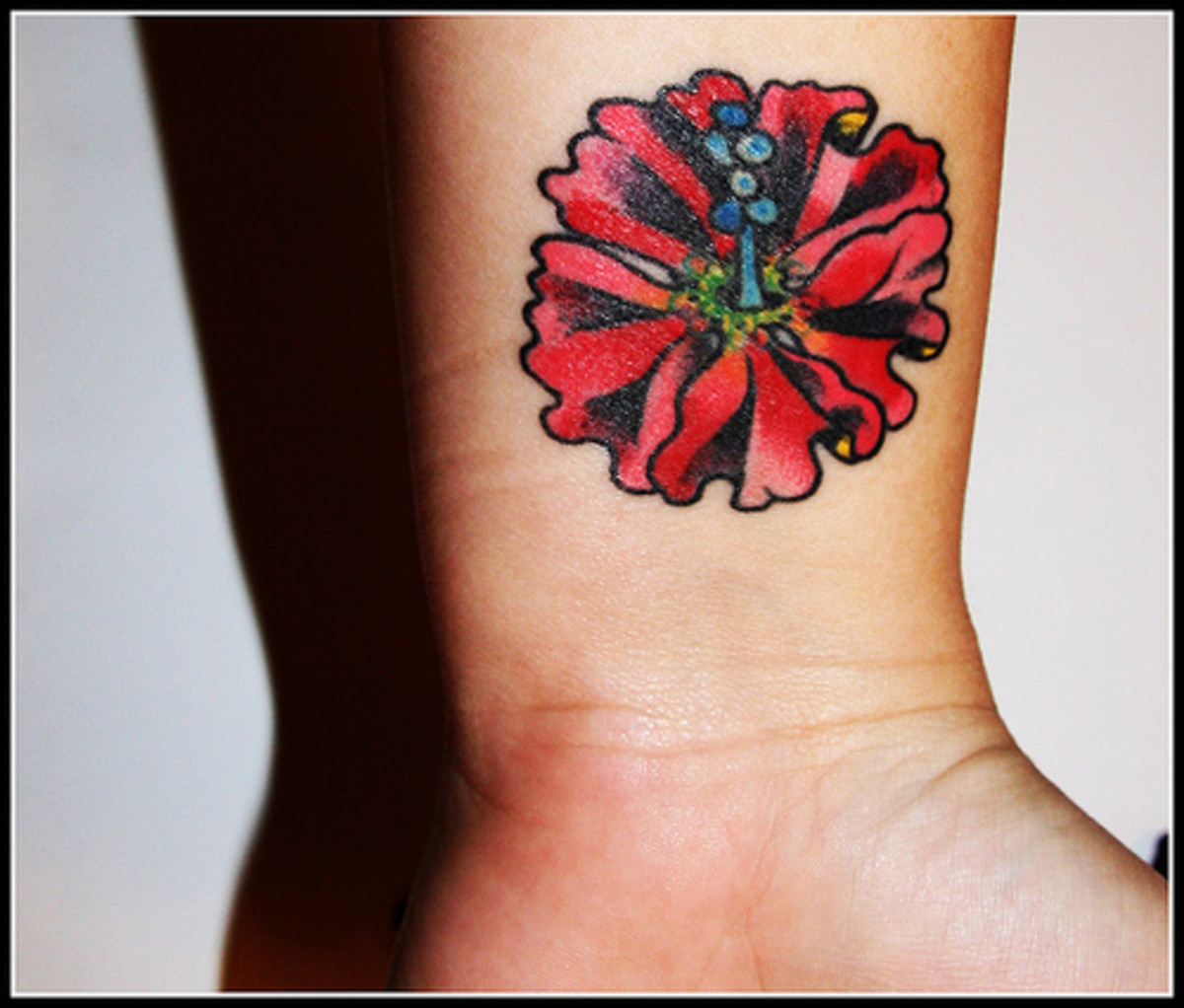 A vibrantly colored hibiscus tattoo