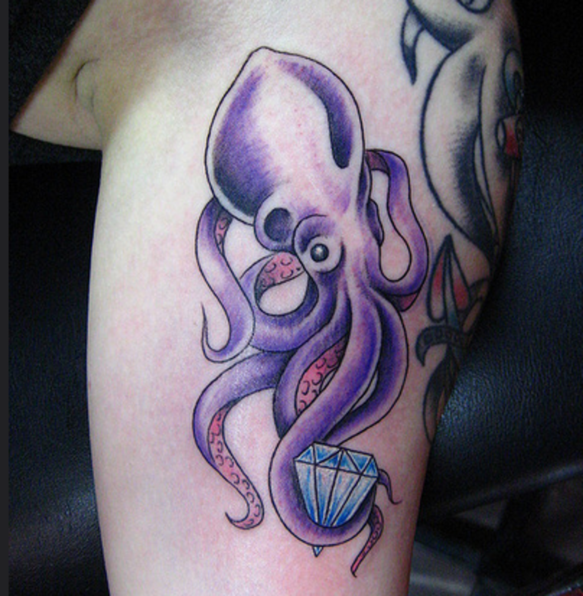 A diamond is held by the tentacles of a squid in this representation.