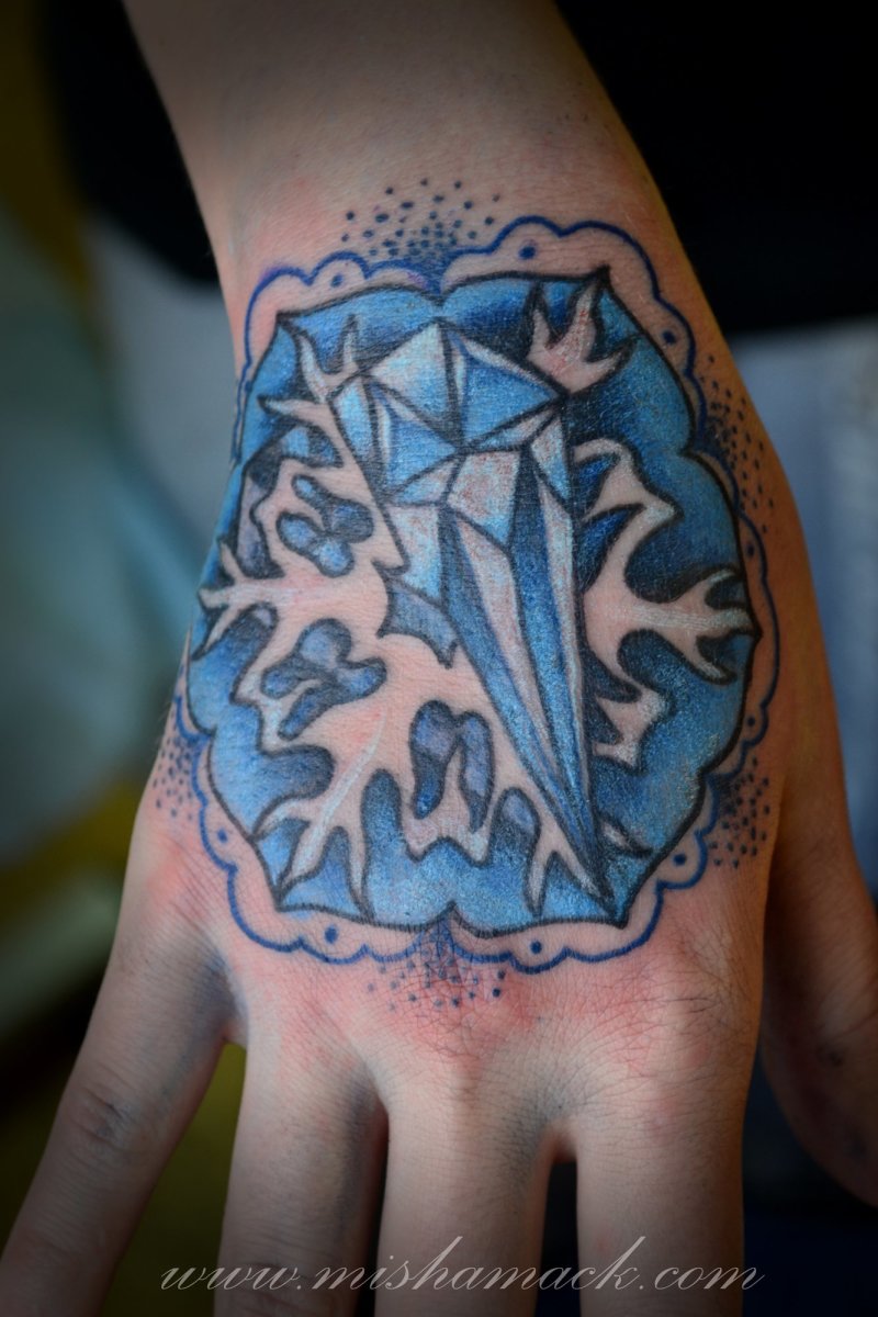 A diamond tattoo worn on the hand.
