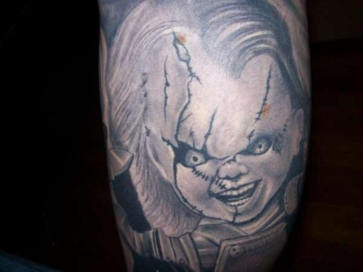 Many Chucky doll tattoos are colored in; this one in gray stands out.