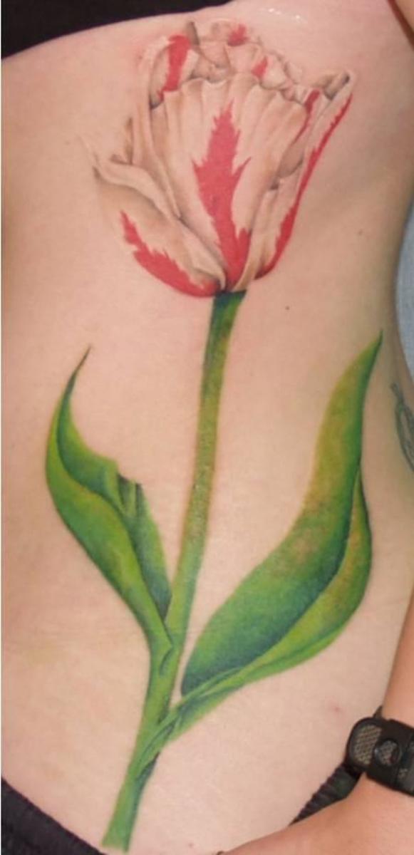 Big, colorful tulip tattoo on one side of the body