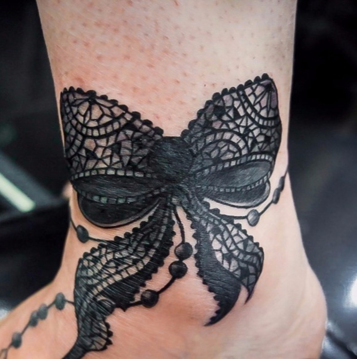A lacy bow tattoo.