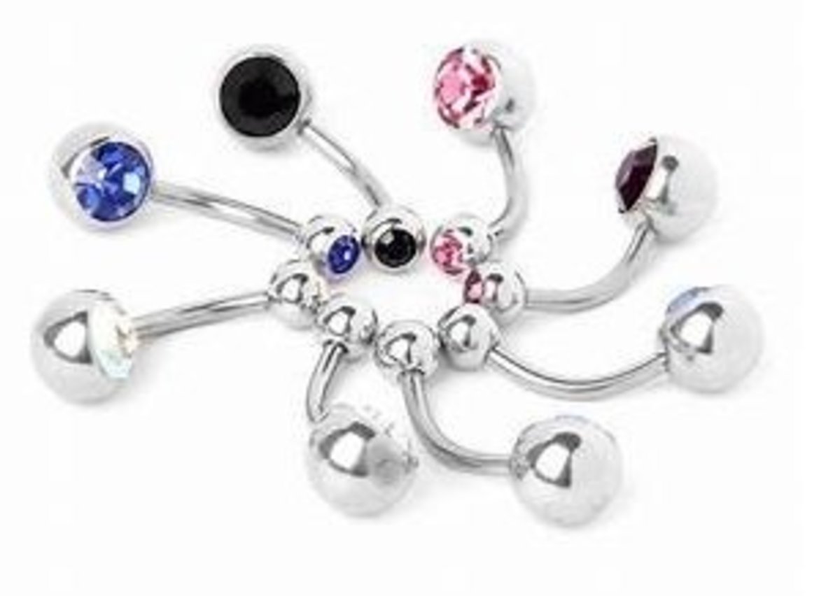 A typical belly button bar has a small  knob on the top end and a slightly larger knob on the bottom end. 