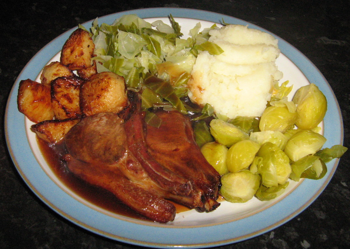 Delicious oven-cooked lamb chops with roast potatoes and cauliflower cheese