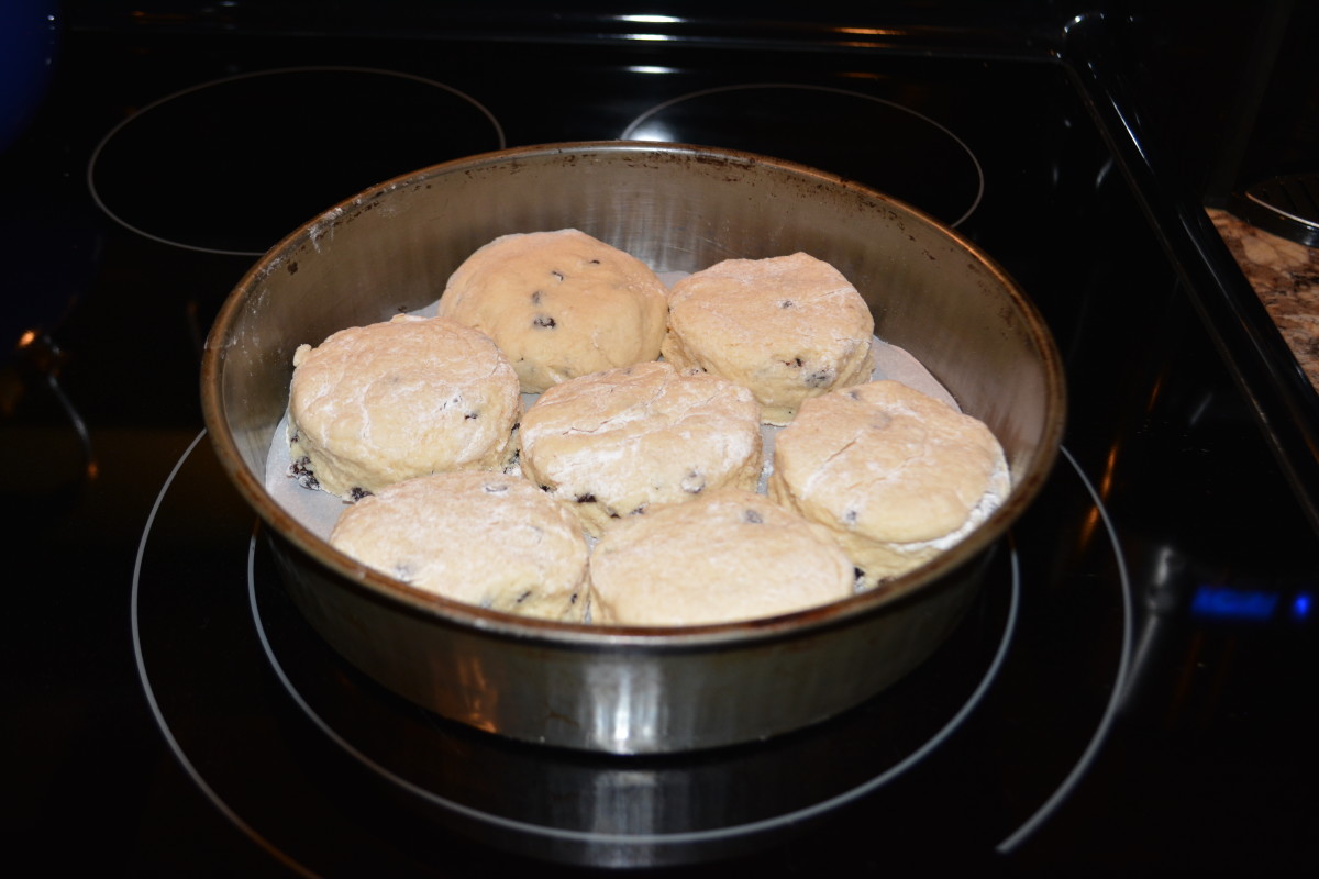 Baking the scones in a pan that requires they touch the sides, as well as each other, forces them to rise rather than spread out.