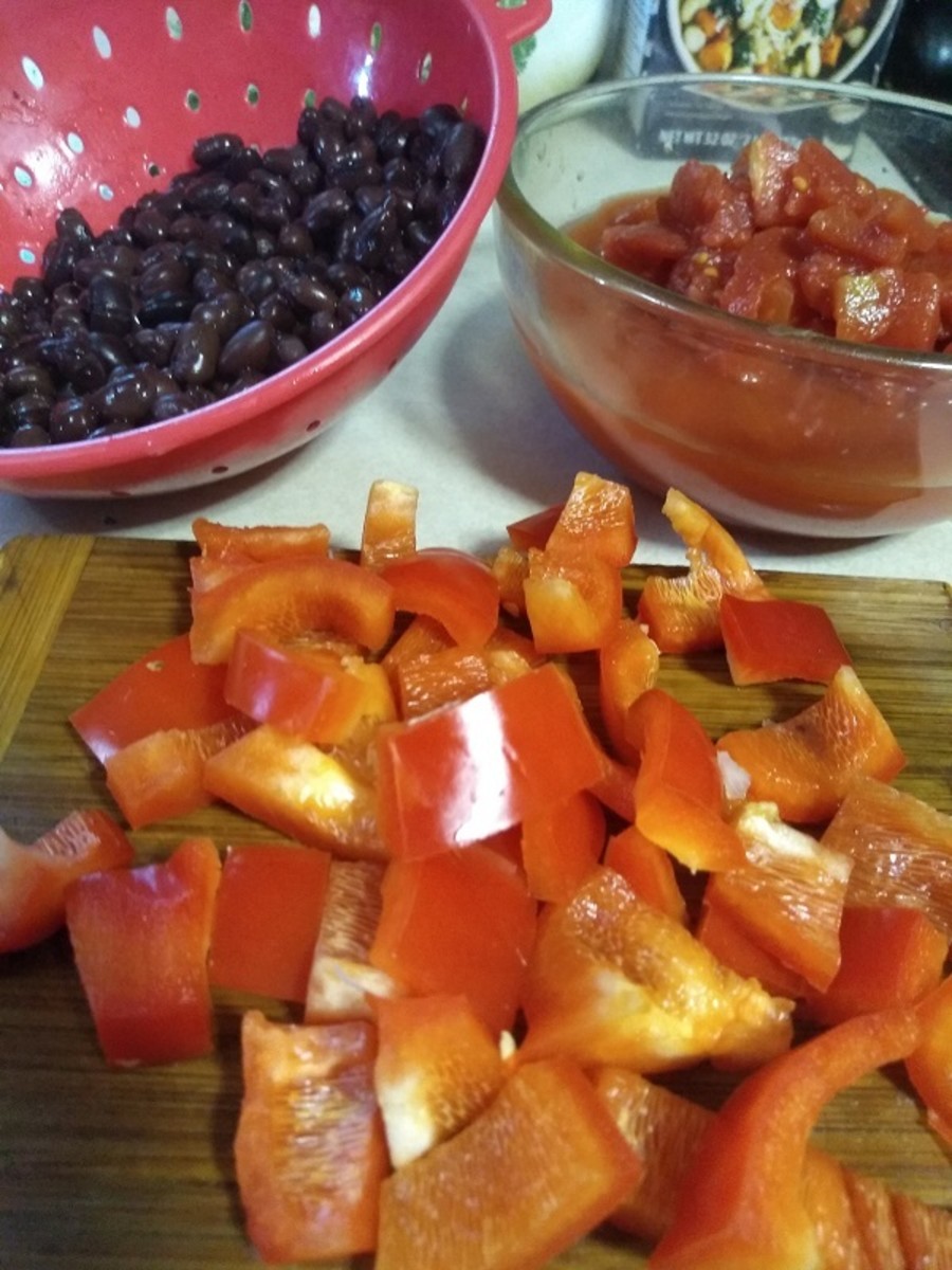Add drained black beans, diced tomatoes, and diced red bell pepper. 