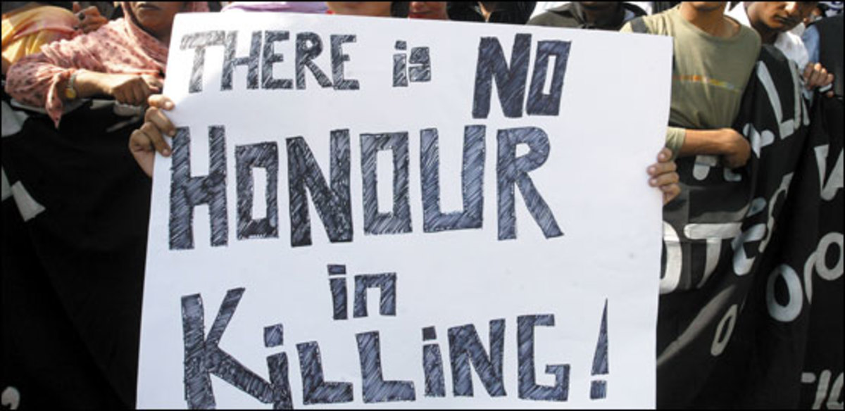 A sign at a gathering to protest "honour" killing