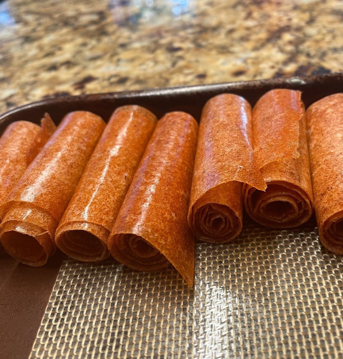 This fruit leather wasn't very sticky so I was able to roll it without parchment, but normally I would use parchment so that the fruit leather didn't stick to itself once rolled up.