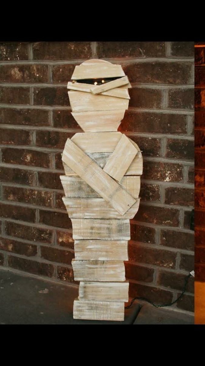 This creepy mummy is made from cardboard that has been altered to look like wood.