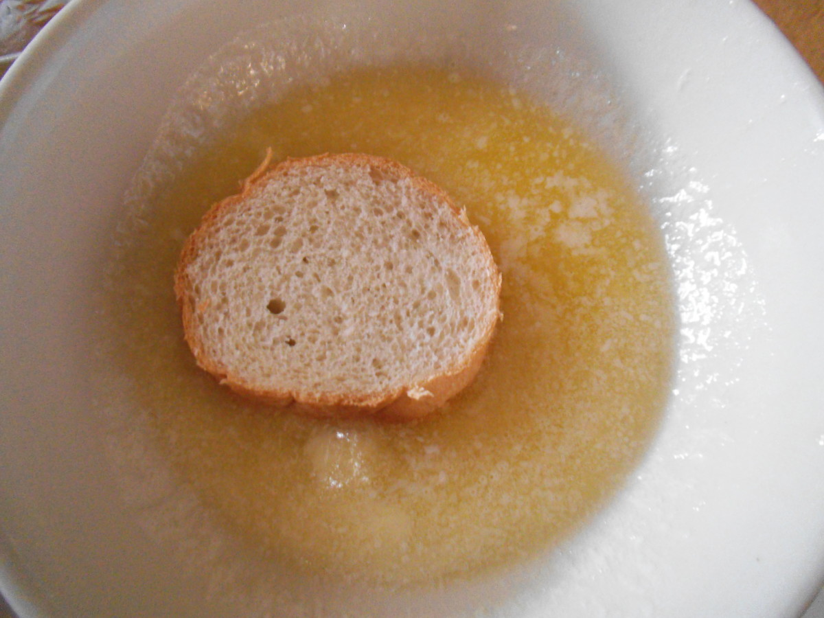 I like to melt my butter in a bowl and dip one side of the French bread rounds into it before placing on a baking sheet.   