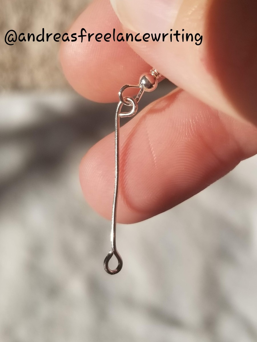 A eyepin and a fishhook looped together.