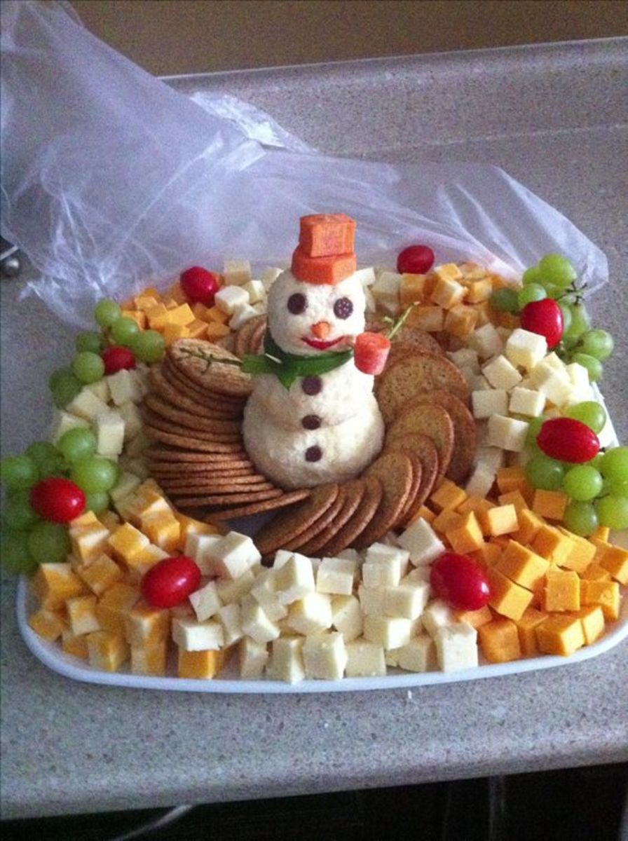 This cheesy snowman has carrot slices for a hat.