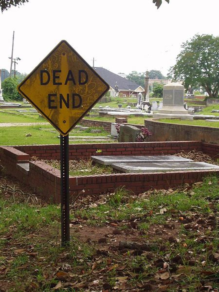 A sign beside a cemetery.