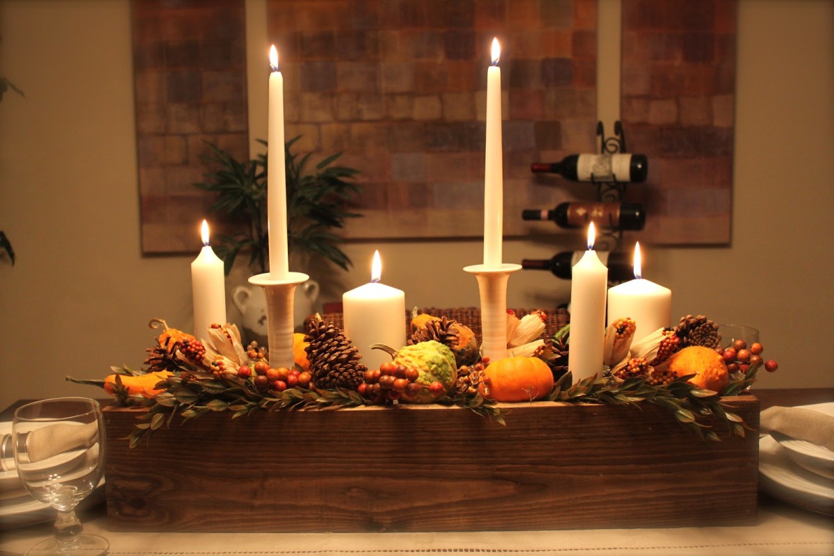 Create a simple centerpiece out of candles, pumpkins, pine cones, and gourds.