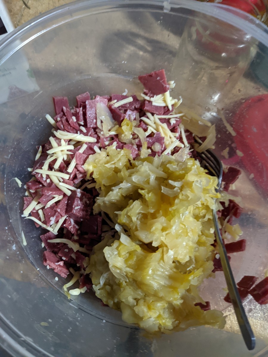 Place squeezed sauerkraut in bowl with cheese and corned beef.