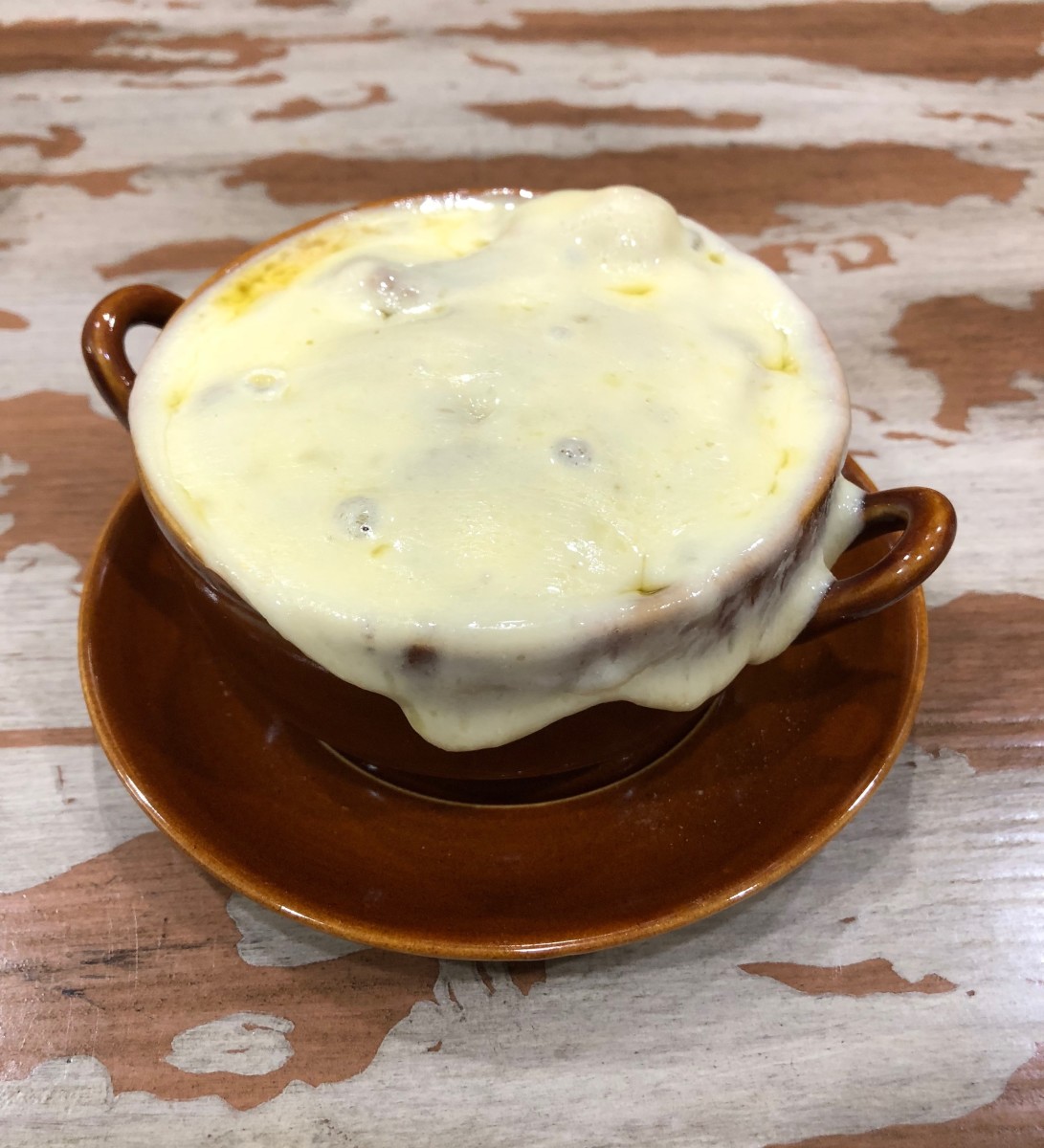 The provolone cheese is melted and the soup is ready to serve.