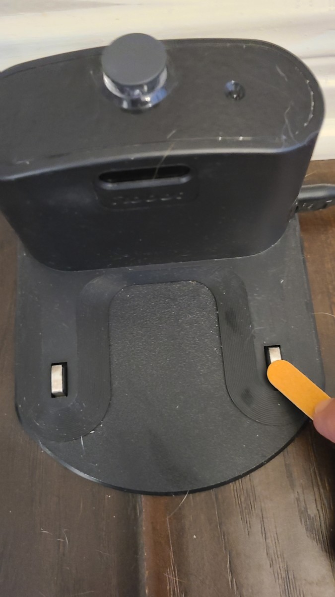 If cleaning the docking station's contacts with a cotton swab and alcohol doesn't work, you may try using an emery board to lightly rough up the contacts.