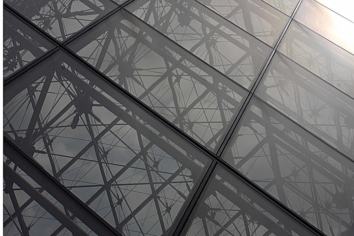The frames of metal and panes of glass in the modern design of the Louvre Pyramid