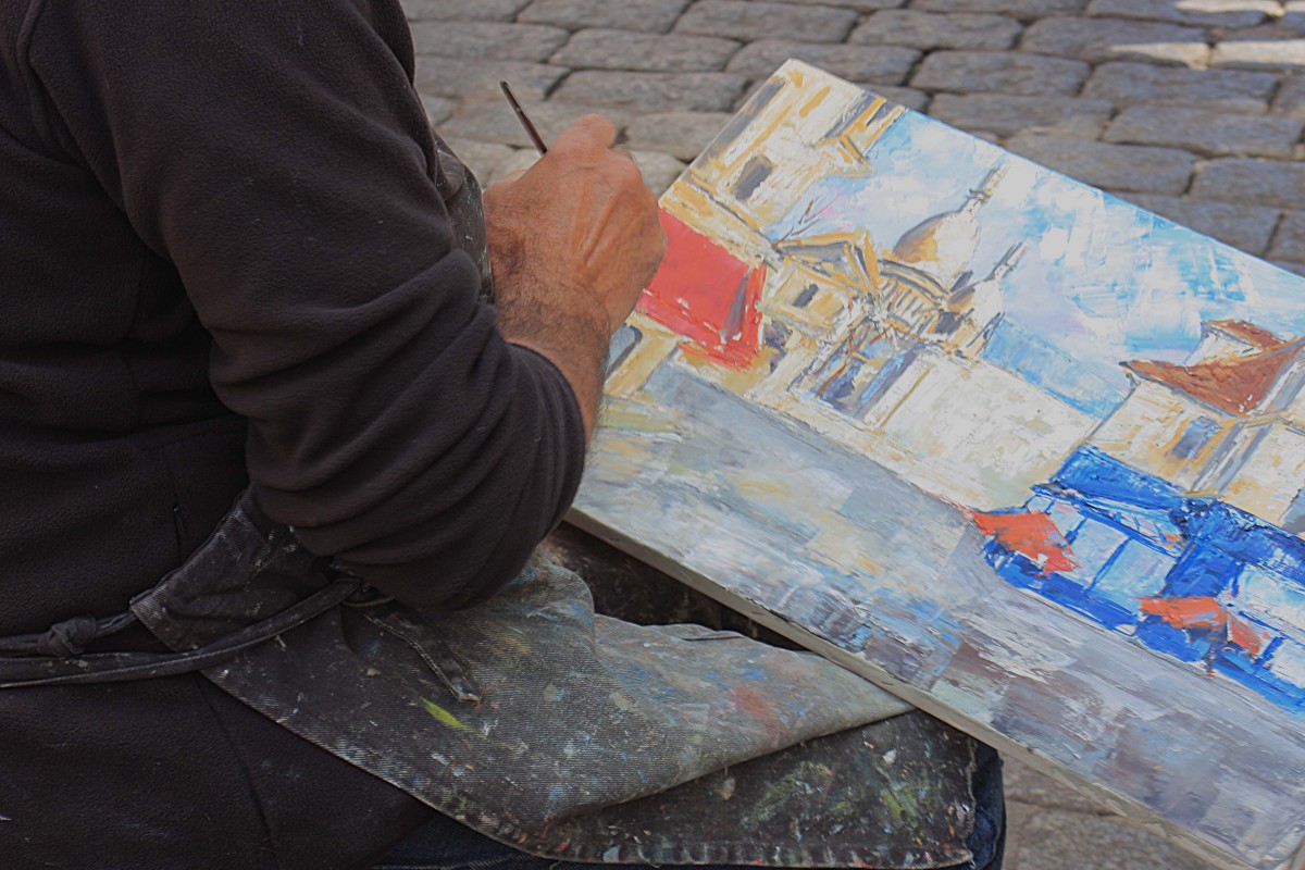 Artist at work on Montmartre's most famous building - the Church of Sacre-Coeur. I wonder how many times he's painted this scene?