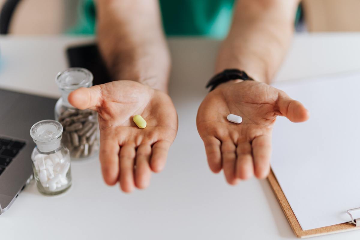 Two hands show a yellow pill on the left, and a white pill on the right. Which is right for you, a full-time job or a part-time job?