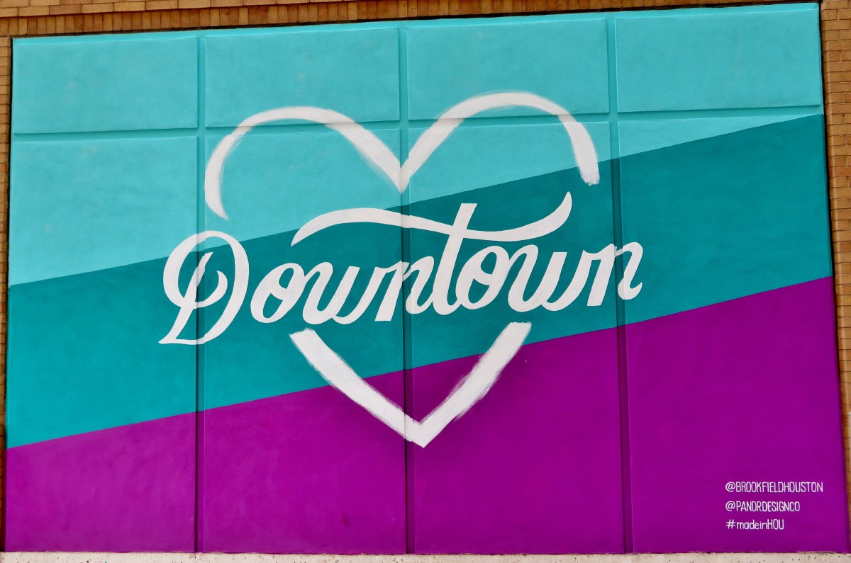 "Downtown" with a heart shape around it is one of the six outdoor murals by Pandr Design Co. in Houston.