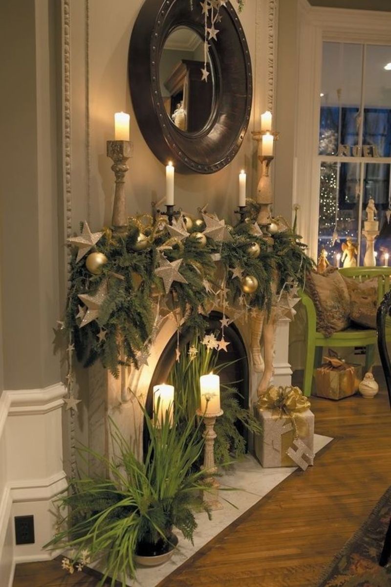 White and Gold Mantel Draped With Greenery and Stars