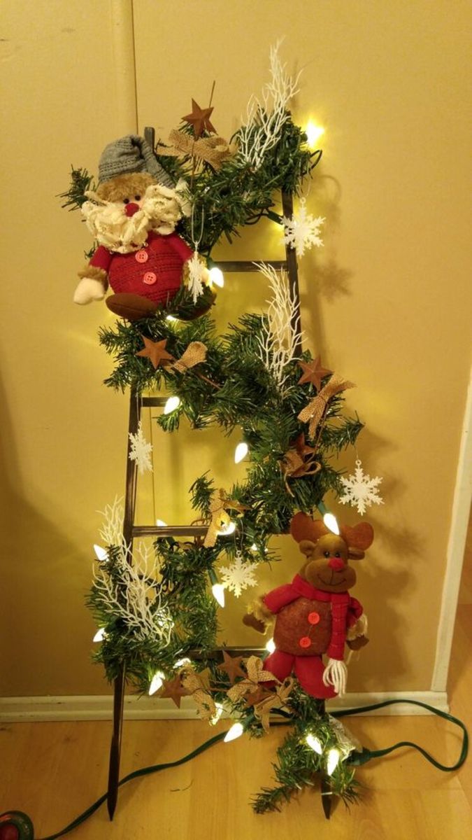 Ladder With Stuffed Christmas Figures and Garland