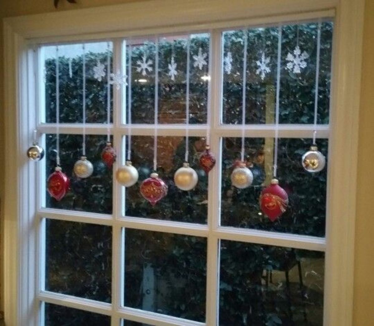 Here's another way to dangle ornaments in your window. Make sure to vary the length of the ribbons!