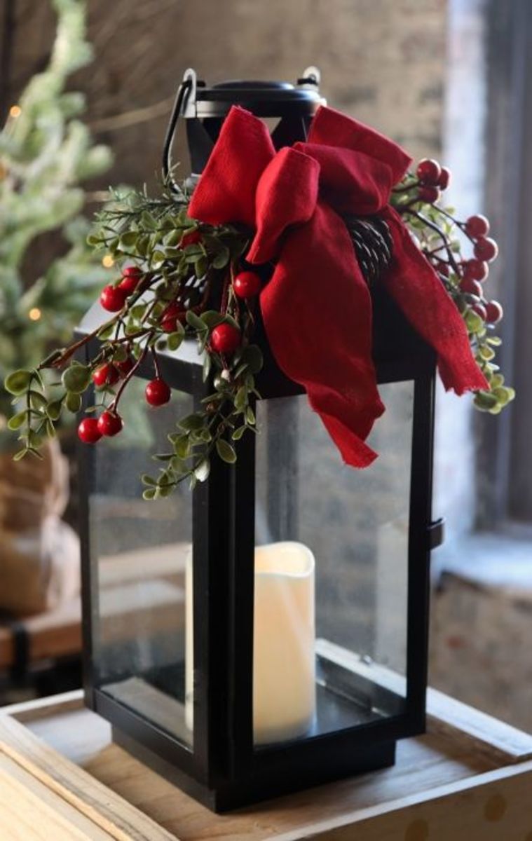 This holiday lantern keeps it simple with an LED candle, some faux berries and branches, and a big red bow.