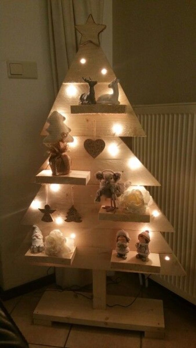 This is another unpainted, rustic tree with shelves and simple decorations.