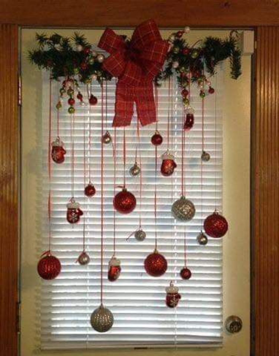Here's a simple window decoration with a small swag, a plaid bow and ornaments dangling from red ribbons.