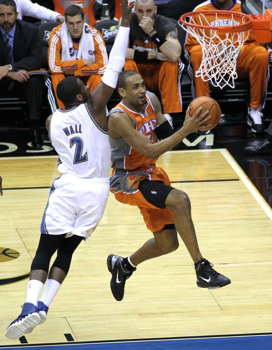 Playing for the Phoenix Suns in an effort to revive his injury-laden career, Grant Hill goes for a contested layup against John Wall.