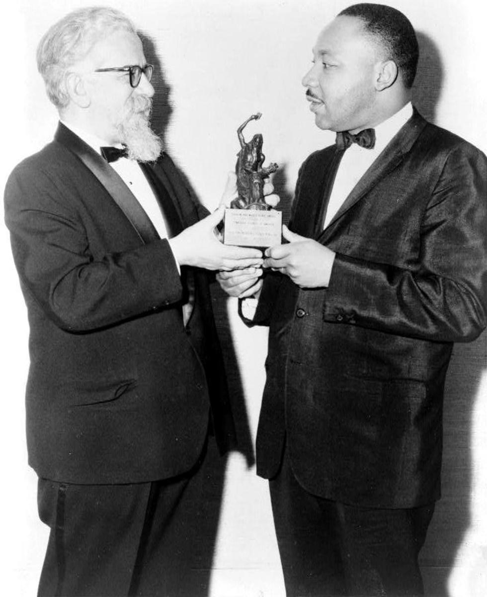 Rabbi Abraham Heschel, three-quarter length portrait, presenting the Judaism and World Peace award to Dr. Martin Luther King, Jr. on December 7, 1965.