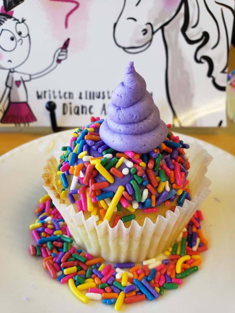 Vanilla rainbow sprinkle cupcakes with purple vanilla frosting