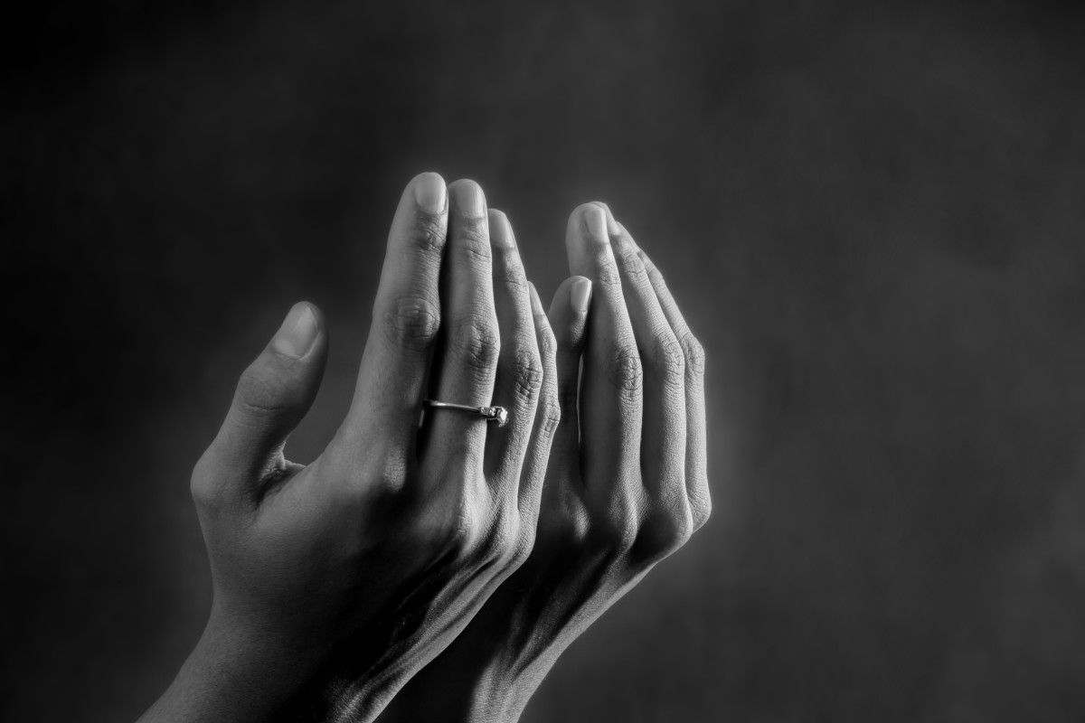 Hands of a worshipper uplifted in prayer