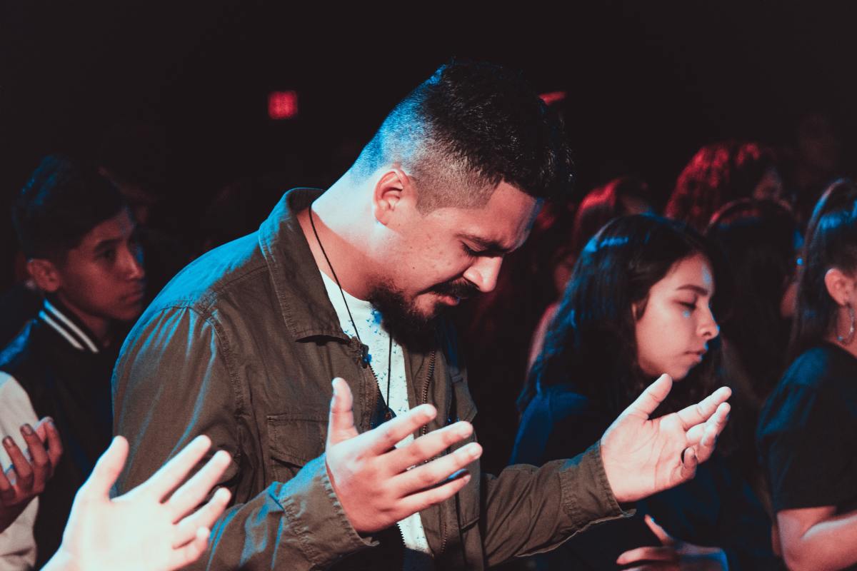 In prayer during a Christian youth convention